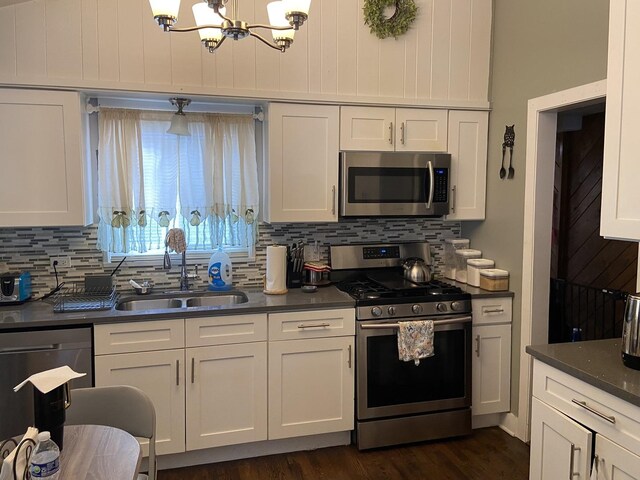 kitchen featuring a notable chandelier, dark hardwood / wood-style flooring, decorative backsplash, sink, and appliances with stainless steel finishes