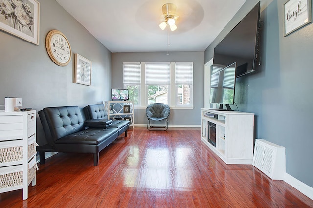 sitting room with wood-type flooring and ceiling fan