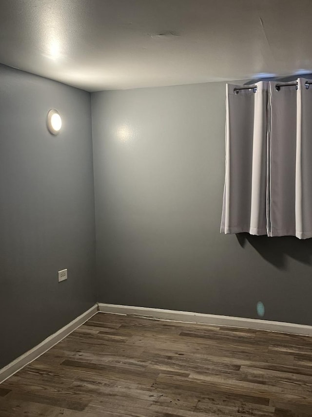 unfurnished room featuring dark hardwood / wood-style flooring