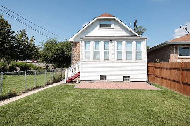 back of property featuring a yard and a patio