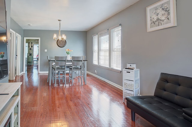 dining space featuring an inviting chandelier and wood-type flooring