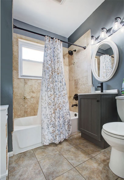 full bathroom with vanity, toilet, tile patterned flooring, and shower / bath combo with shower curtain