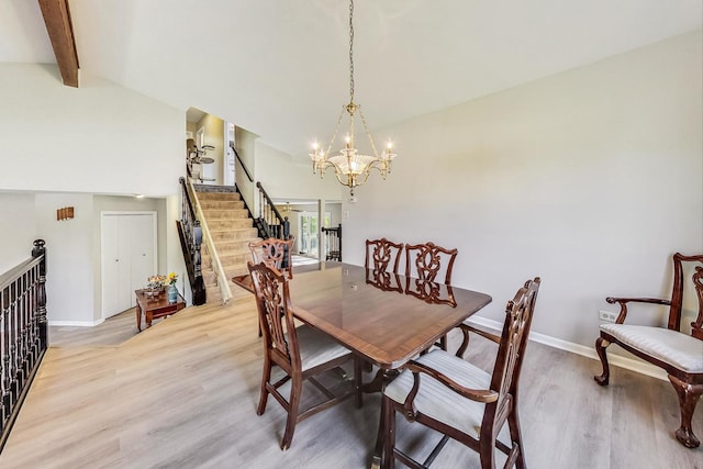 dining area featuring high vaulted ceiling, beamed ceiling, a chandelier, and light hardwood / wood-style flooring