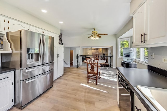 kitchen with appliances with stainless steel finishes, light wood-type flooring, white cabinetry, and sink