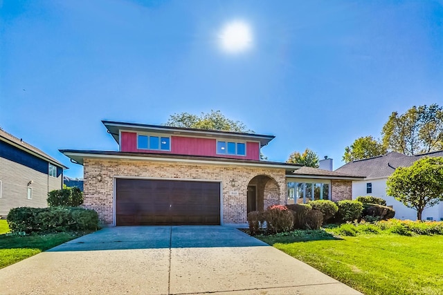 view of front of house with a front yard and a garage