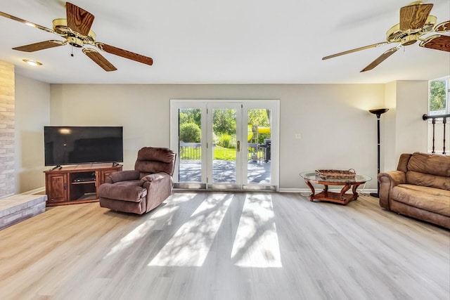 living room featuring ceiling fan and light wood-type flooring