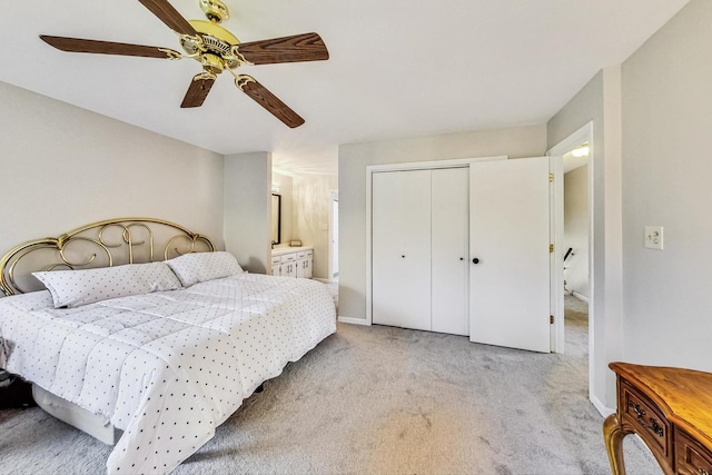 carpeted bedroom with a closet and ceiling fan