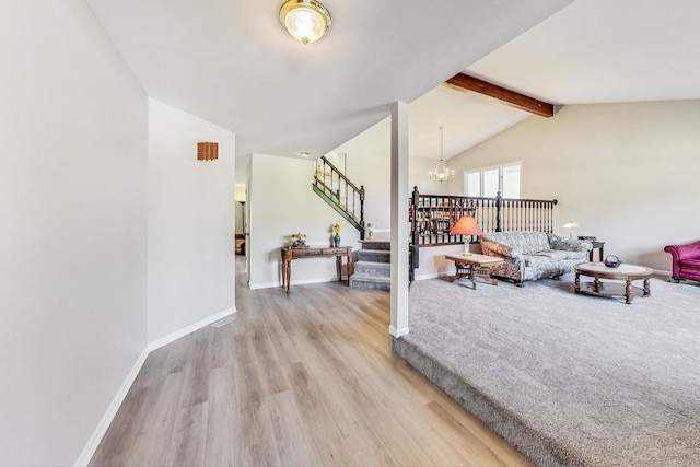 living room with vaulted ceiling with beams, an inviting chandelier, and light hardwood / wood-style flooring