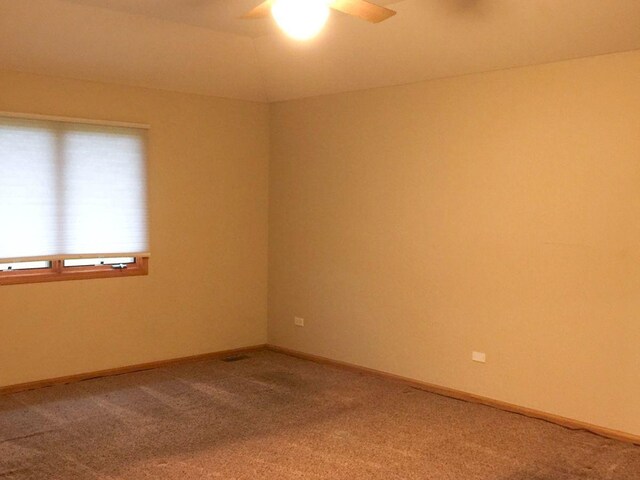 spare room with carpet flooring and ceiling fan