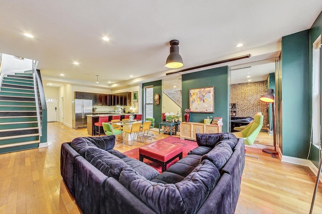 living room with light wood-type flooring and a fireplace