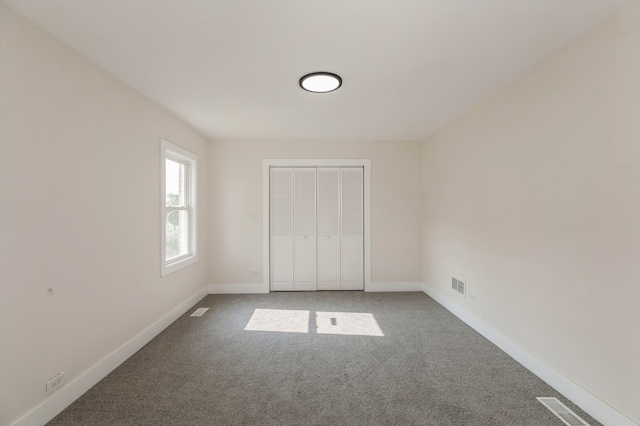 unfurnished bedroom featuring a closet and carpet