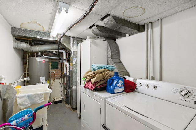 laundry area featuring washing machine and dryer and water heater