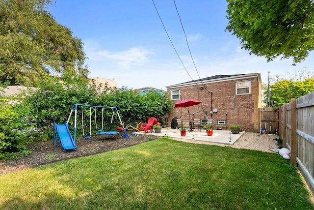 view of yard with a playground and a patio