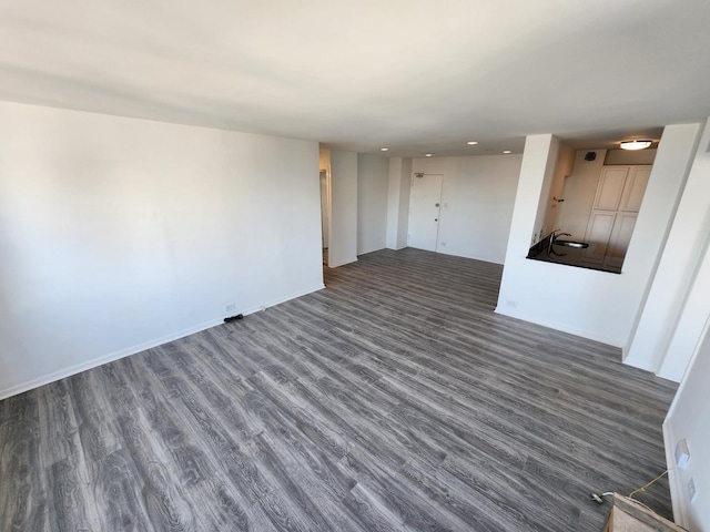 unfurnished living room featuring dark wood-type flooring