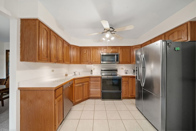 kitchen with light tile patterned floors, sink, ceiling fan, and appliances with stainless steel finishes