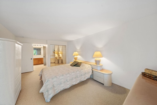 carpeted bedroom featuring ensuite bathroom