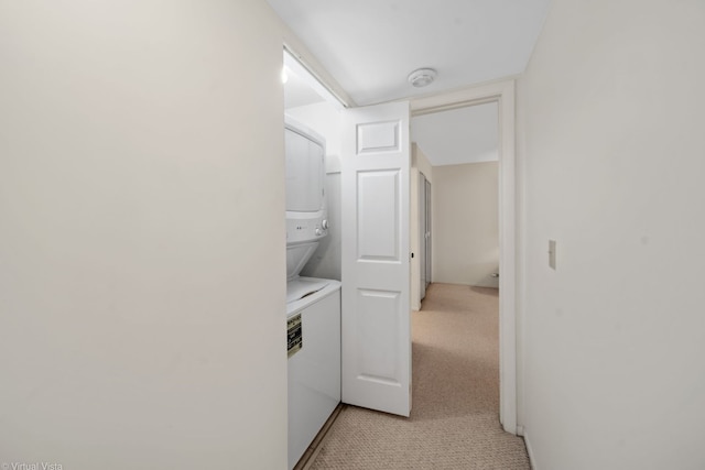 laundry area with stacked washing maching and dryer