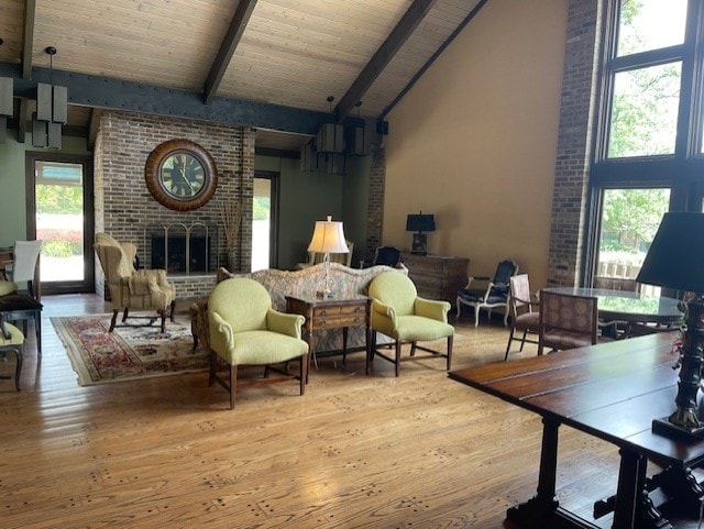 living area with wood-type flooring, beam ceiling, and high vaulted ceiling