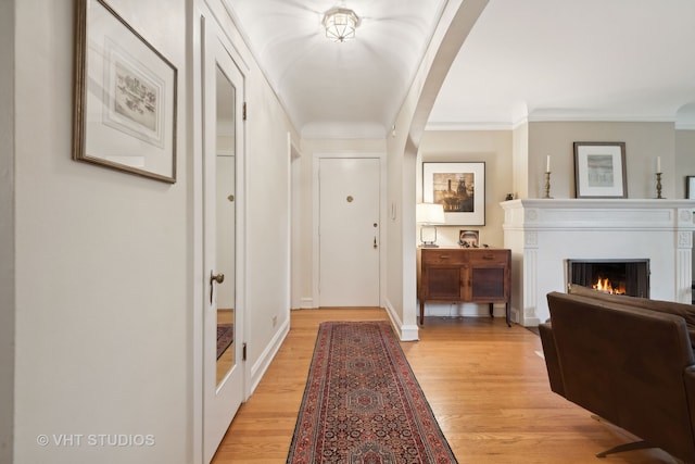 interior space with ornamental molding and light wood-type flooring