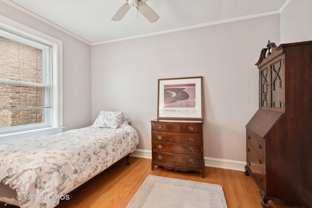 bedroom with light hardwood / wood-style flooring, ornamental molding, and ceiling fan