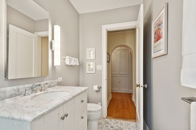 bathroom with tile patterned flooring, toilet, and vanity