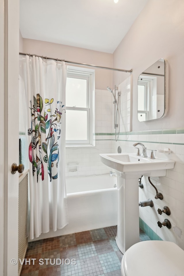 bathroom with backsplash, tile patterned flooring, toilet, and tile walls