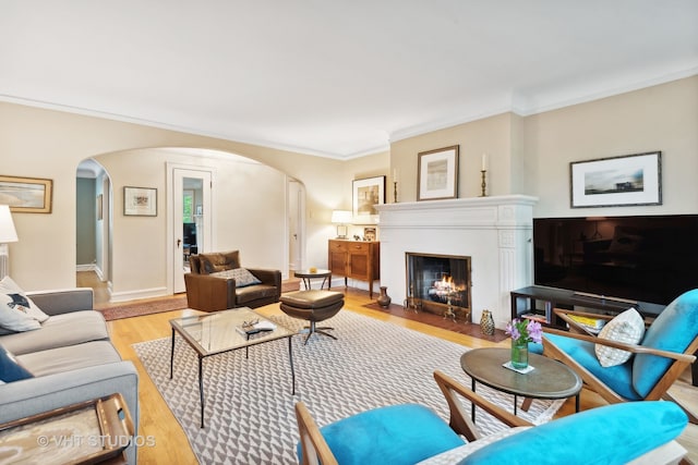 living room featuring crown molding and light wood-type flooring