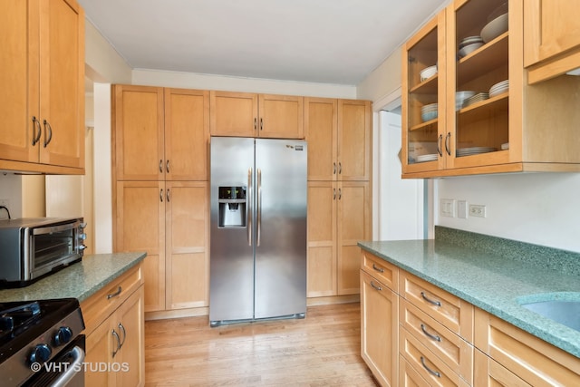 kitchen featuring range, light wood-type flooring, and stainless steel refrigerator with ice dispenser