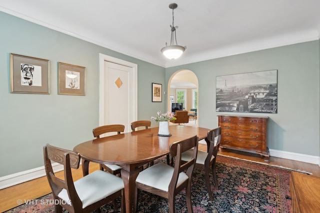 dining room featuring hardwood / wood-style flooring and crown molding