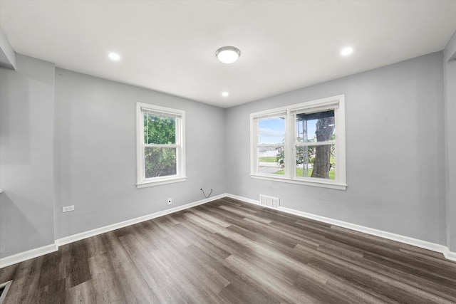 spare room with wood-type flooring