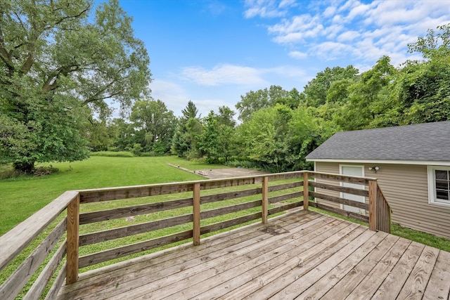 wooden terrace featuring a yard