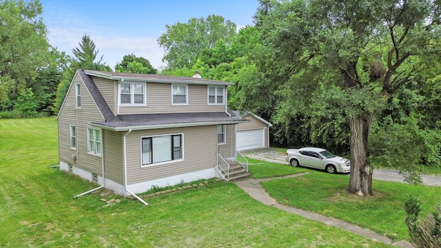 view of front of property featuring a garage and a front lawn