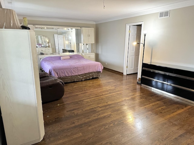 bedroom with crown molding and dark hardwood / wood-style flooring