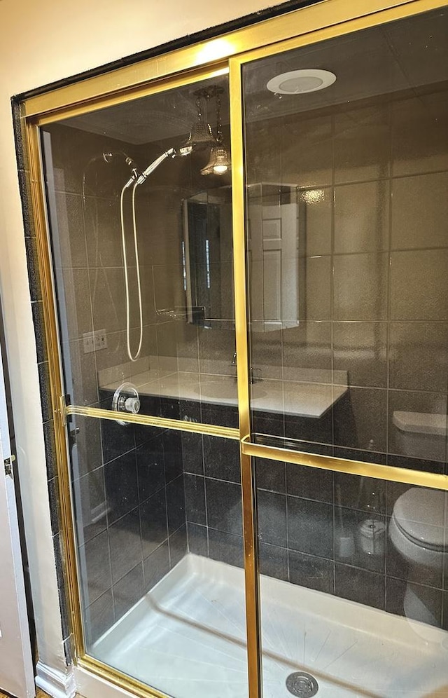 bathroom featuring a shower with door