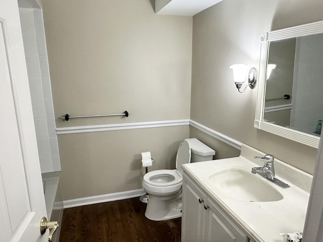 bathroom featuring wood-type flooring, toilet, a bathtub, and vanity