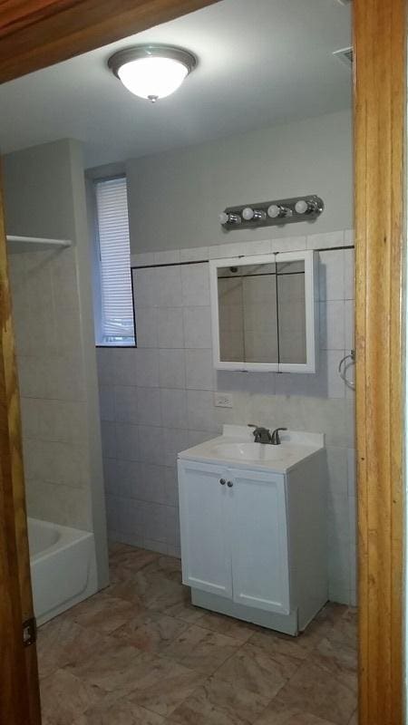 bathroom featuring tile walls and vanity