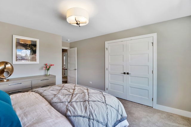 bedroom with light carpet and a closet