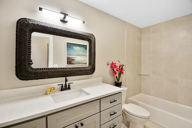 full bathroom featuring vanity, tiled shower / bath, and toilet