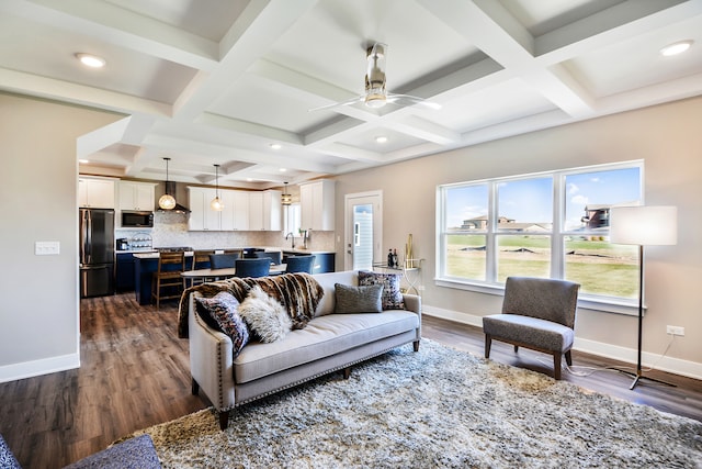 living room featuring beamed ceiling, sink, dark hardwood / wood-style floors, ceiling fan, and coffered ceiling