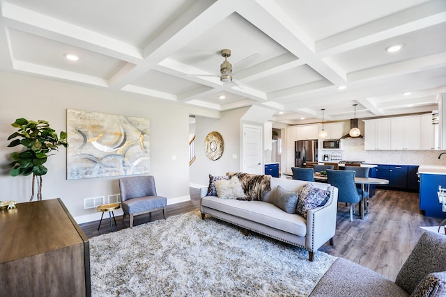 living room featuring coffered ceiling, hardwood / wood-style floors, and beam ceiling