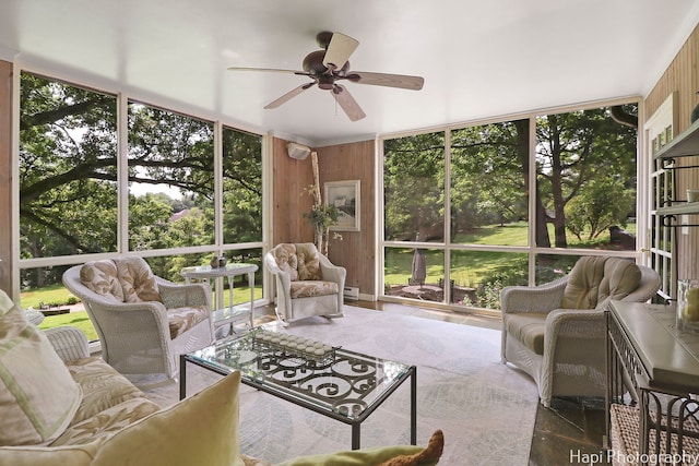 sunroom / solarium featuring ceiling fan