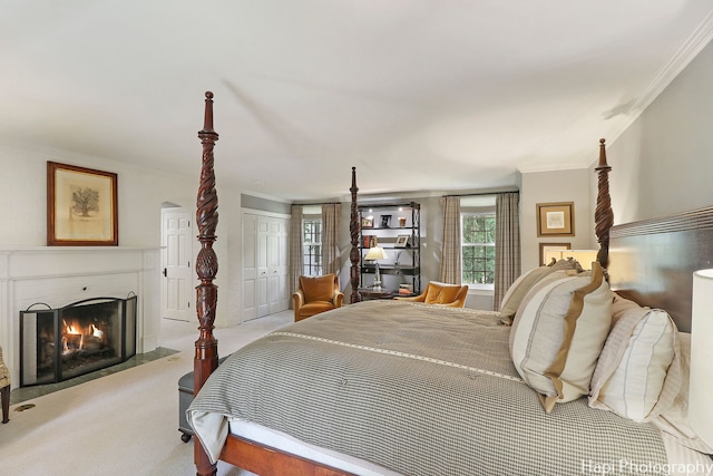 bedroom featuring ornamental molding, a closet, and light colored carpet