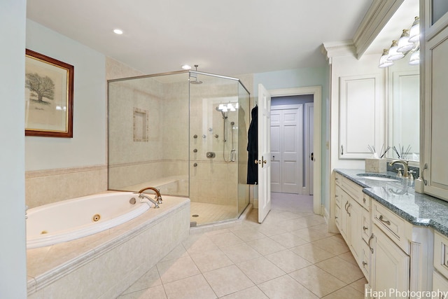 bathroom featuring shower with separate bathtub, vanity, and tile patterned flooring