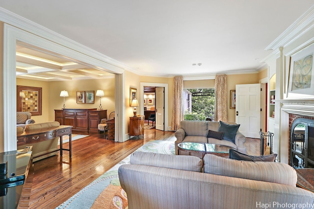 living room with hardwood / wood-style floors, crown molding, coffered ceiling, and beam ceiling