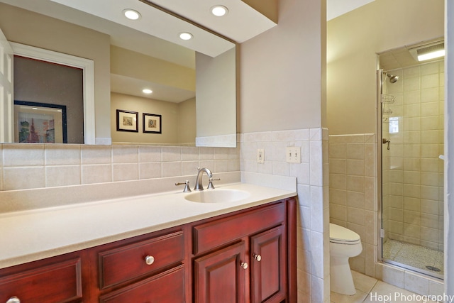 bathroom with decorative backsplash, tile walls, toilet, tile patterned floors, and vanity