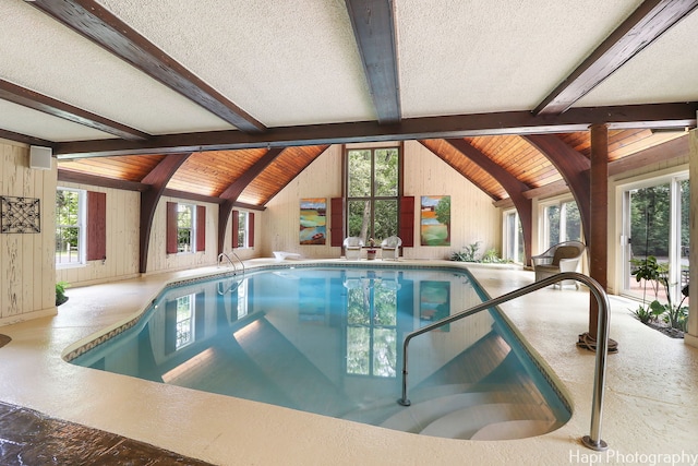 view of swimming pool featuring a hot tub