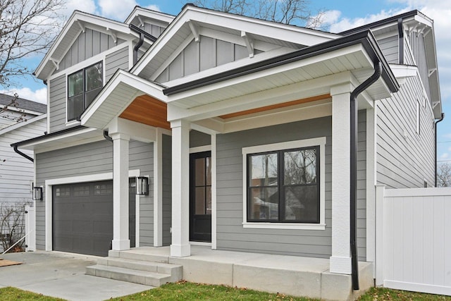 view of front of house featuring a porch and a garage