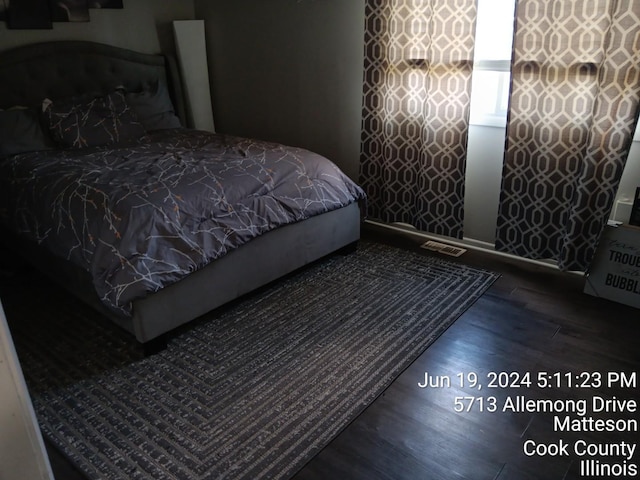 bedroom featuring dark hardwood / wood-style flooring