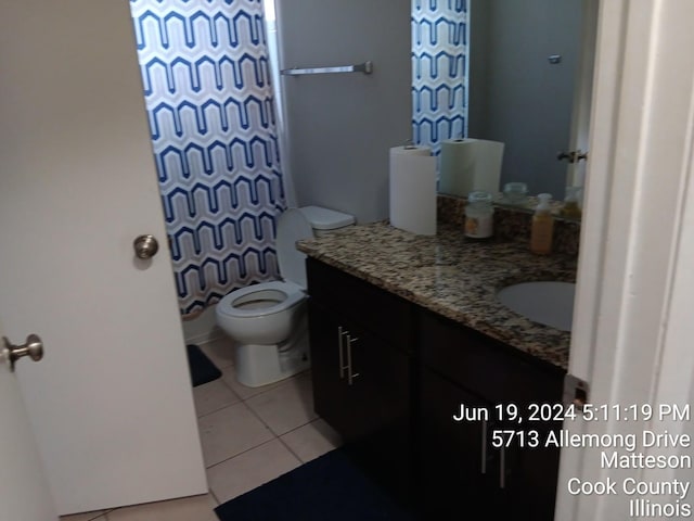 bathroom with vanity, tile patterned flooring, and toilet