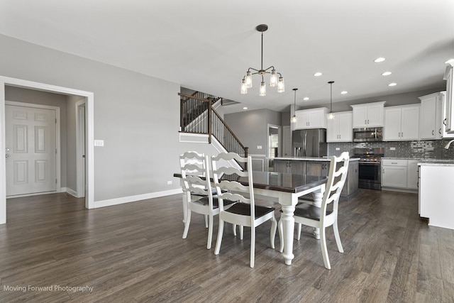 dining area with an inviting chandelier and dark hardwood / wood-style floors